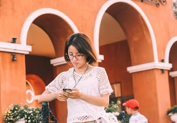 Woman Using Smartphone While Walking