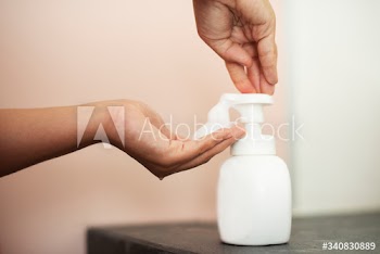 Woman using soap to clean hands and prevent coronavirus