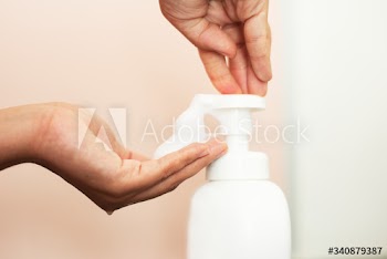 Woman using soap to clean hands and prevent coronavirus