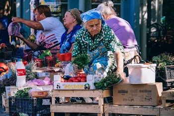 woman vending tomatoes on stall