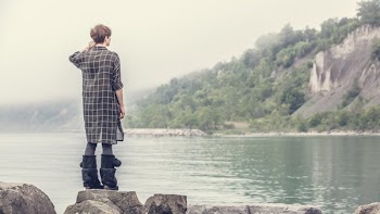 Woman Viewing Rocky Shoreline
