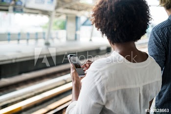 Woman waiting and playing on her phone