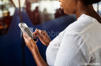 Woman waiting and playing on her phone