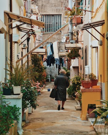 Woman Walking Along Alley