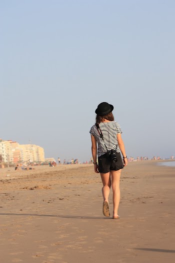 Woman Walking Along the Seashore