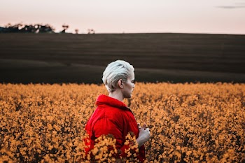 Woman Walking At A Field Of Flowers