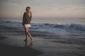 Woman Walking Beside Seashore