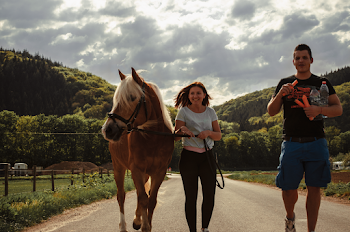 Woman Walking Between Horse and a Man