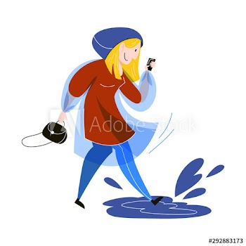Woman walking dressed in the raincoat under the rain