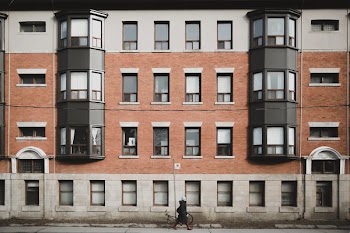 woman walking in front of apartment building
