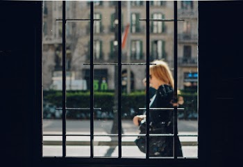 Woman Walking in Front of Building