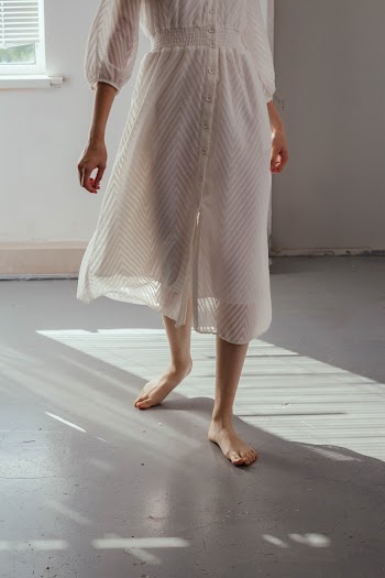 Woman Walking in Front of Window