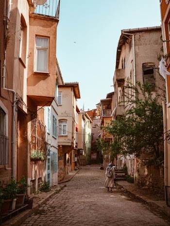 Woman Walking In Middle Of Empty Street