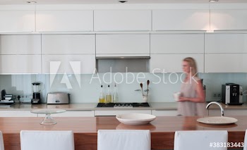 Woman walking in modern kitchen
