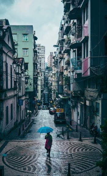 woman walking in the middle of street