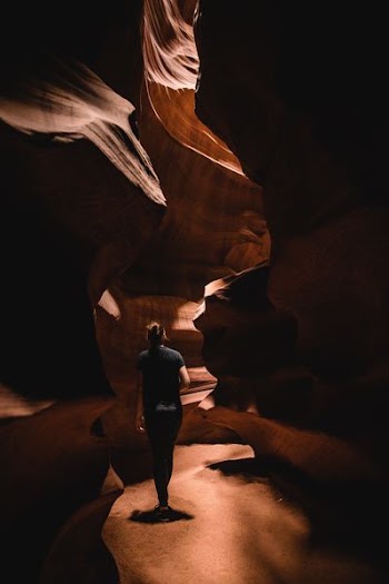 woman walking inside Antelope Canyon