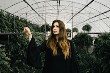 woman walking inside greenhouse