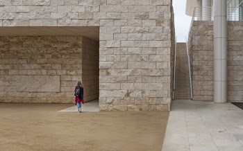 Woman Walking Near Brick Building