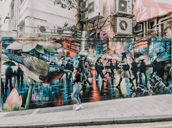 Woman Walking Near Graffiti Wall
