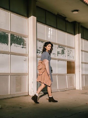 woman walking near white building
