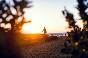 Woman walking on a beach in a sunset in Melbourne