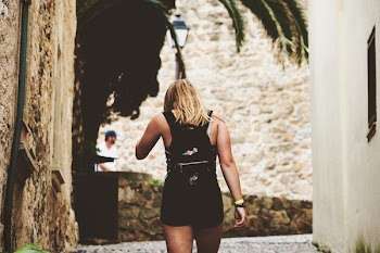 Woman Walking on Alley