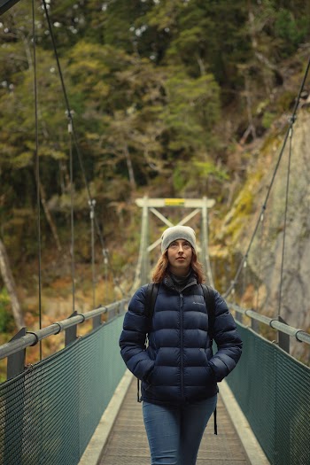 Woman Walking on Bridge