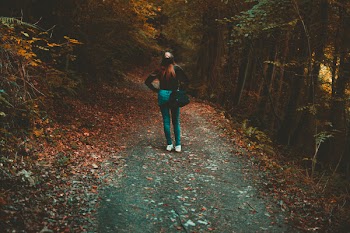 Woman Walking on Forest Trail
