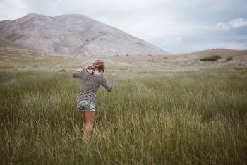 woman walking on grass field