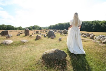Woman Walking on Grass Field