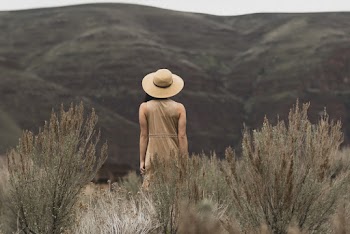 Woman Walking on Grassfield