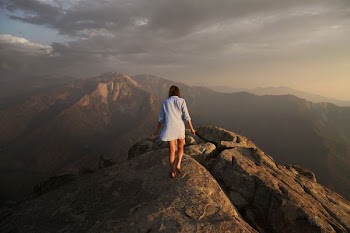 woman walking on grey rock mountain