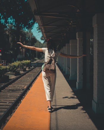 Woman Walking On Station Platform