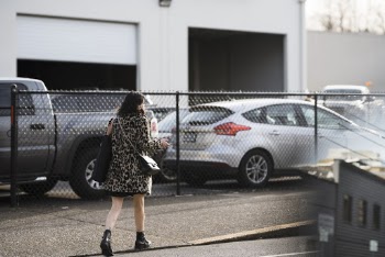 Woman Walking on Street Near Vehicles