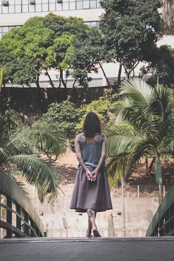 Woman Walking on Wooden Bridge