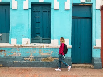 Woman Walking Street With Blue Building
