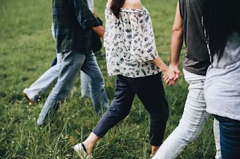 woman walking to the green grass field