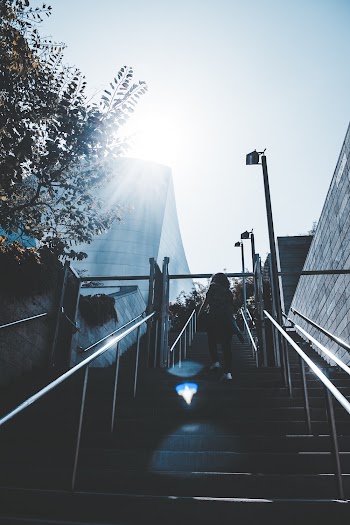 Woman Walking Upward a Staircase