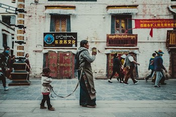 woman walking with hand holding her tie on street