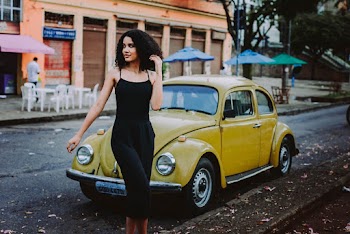 Woman Walks Behind Yellow Volkswagen Beetle