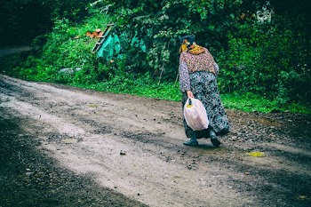 Woman Walks on Brown Soil
