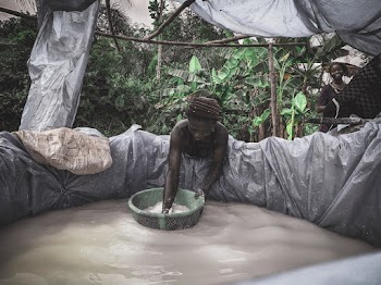 Woman Washing White Textile on Water