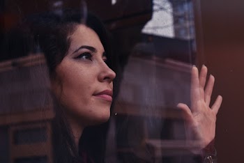 Woman Watching Outside from the Glass Window
