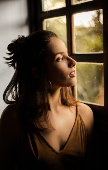Woman Watching Window Wearing Brown V-neck Sleeveless Shirt