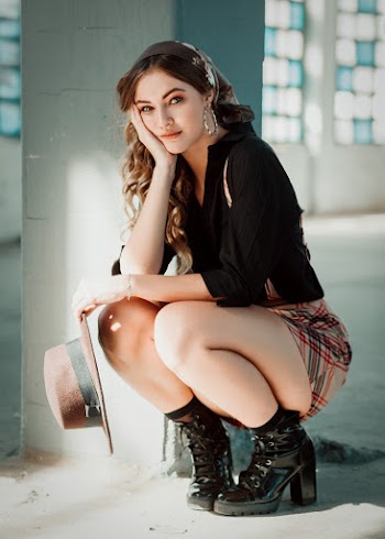 Woman Wearing A Black Top And Mini Skirt