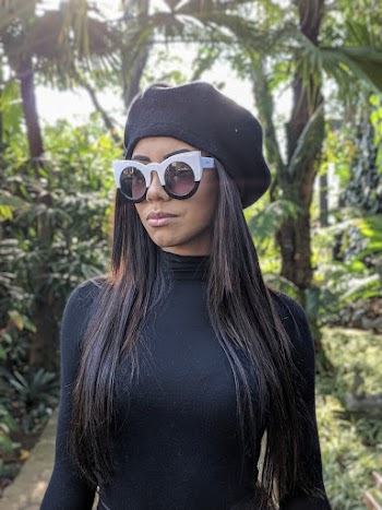 Woman Wearing a Cap and Sunglasses