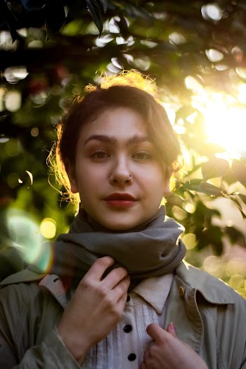 Woman Wearing A Coat And A Scarf