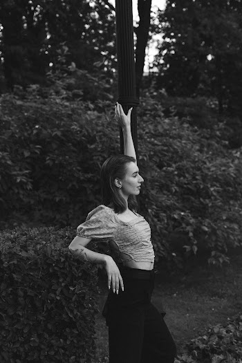 Woman Wearing a Crop Top Holding a Light Post · Free Stock Photo