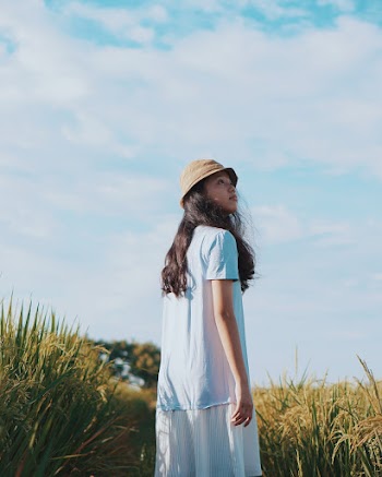 Woman Wearing A Dress Standing Besides Grass