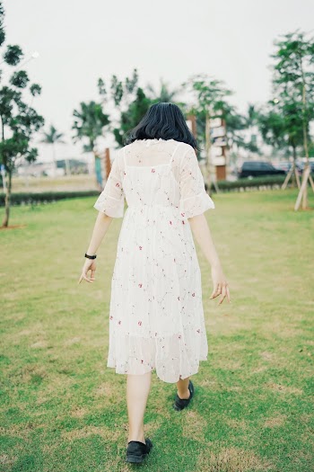Woman  Wearing a dress Walking on Grass